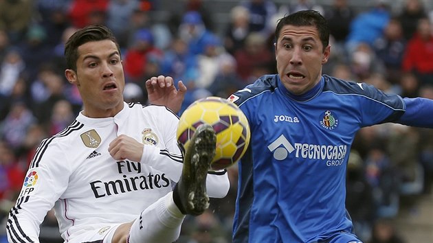 CO TO S TM MEM DL? Cristiano Ronaldo (vlevo) odehrv balon ped Robertem Lagem z Getafe.