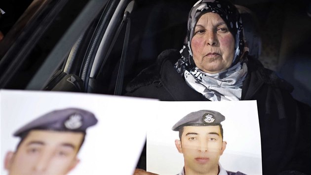 Matka zajatho jordnskho pilota Maze al-Kassby s portrty svho syna (Ammn, 27. ledna 2015).