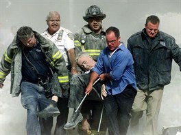 Rescue workers carry fatally injured New York City Fire Department Chaplain,...