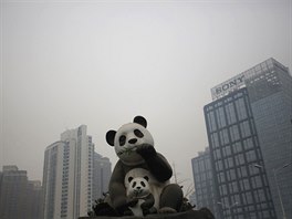 A combination picture shows statues of pandas on a sunny day (L) and...