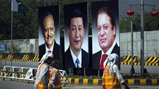 Pákistántí dlníci ped billboardy propagující návtvu ínského prezidenta Si...