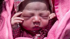 Maya Tamang's one-day-old daughter lies at a temporary makeshift outside... Maya Tamang's one-day-old daughter lies at a temporary makeshift outside...