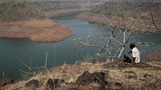 A villager sits on a hill overlooking part of Bhatsa dam on the outskirts of... A villager sits on a hill overlooking part of Bhatsa dam on the outskirts of...