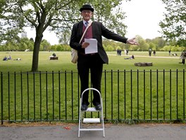 Matthew, 60, a speaker on Christianity, gestures on a stepladder at Speakers'...