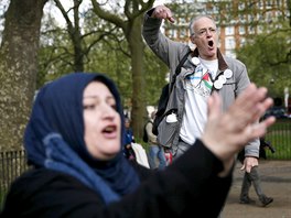 A speaker (back) addresses a crowd next to a heckler at Speakers' Corner in...