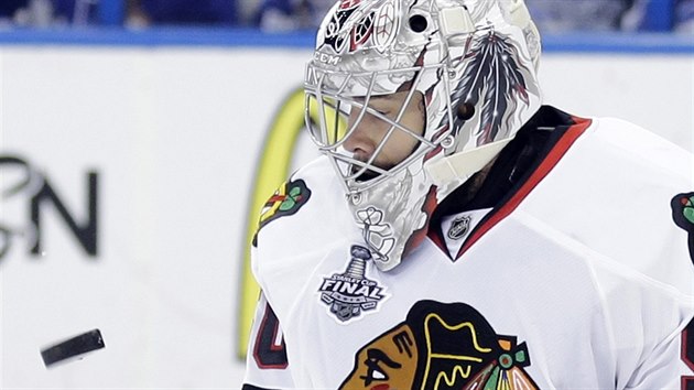 Brank Chicaga Corey Crawford sleduje letc puk.