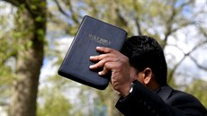 A Christian speaker holds a copy of the Bible at Speakers' Corner in Hyde... A Christian speaker holds a copy of the Bible at Speakers' Corner in Hyde...