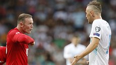 Anglický fotbalista Wayne Rooney (vlevo) ve vzruené debat se slovinským...