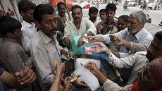 Lidé si kupují led u pouliního prodavae bhem vlny veder v Pákistánu. (24. 6....