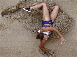 Britain's Jessica Ennis-Hill lies in the sand as she competes in the women's...