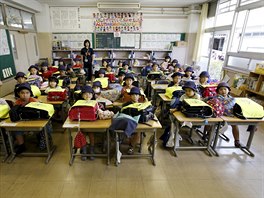 First grade students and their class teacher Teruko Takakusaki (in background)...