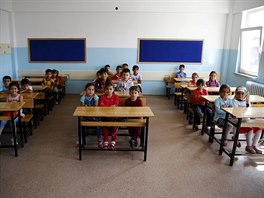 Syrian refugee students in second grade wait for the start of their first...