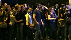 Lidé poblí koncertní sín Bataclan v Paíi sledují situaci po teroristických...