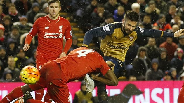 Olivier Giroud stílí, obtavý Kolo Touré (íslo 4) jeho pokusu nezabránil...