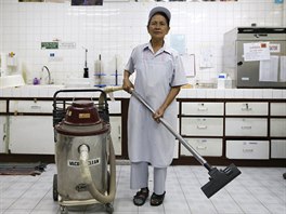 Darunee Kamwong, a 72-year-old cleaner, poses for a portrait while working in...