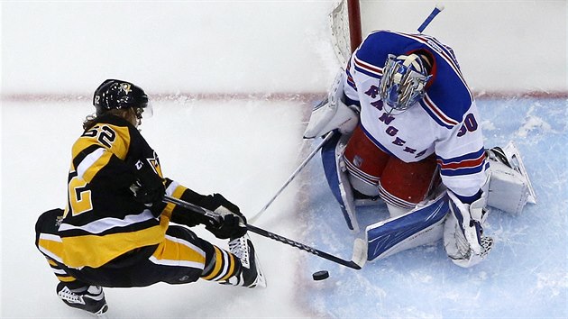 Henrik Lundqvist, brank New York Rangers, zasahuje proti Carlu Hagelinovi z Pittsburghu.