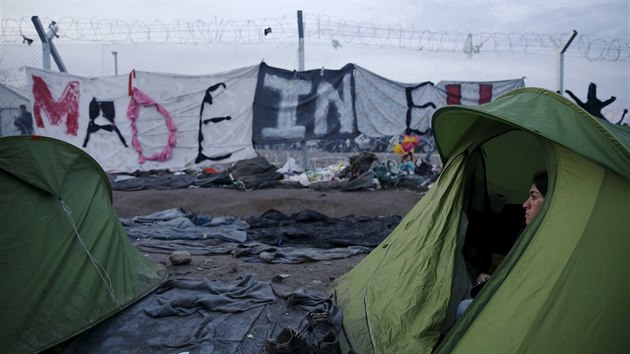 Migranti ekajc na ecko-makedonsk hranici pobl Idomeni. Benci na plot povsili npis Made in EU. (8. bezna 2016).