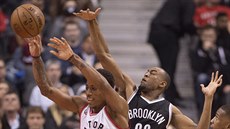 DeMar DeRozan (vlevo) z Toronta pihrává mí, Markel Brown z Brooklynu ho...