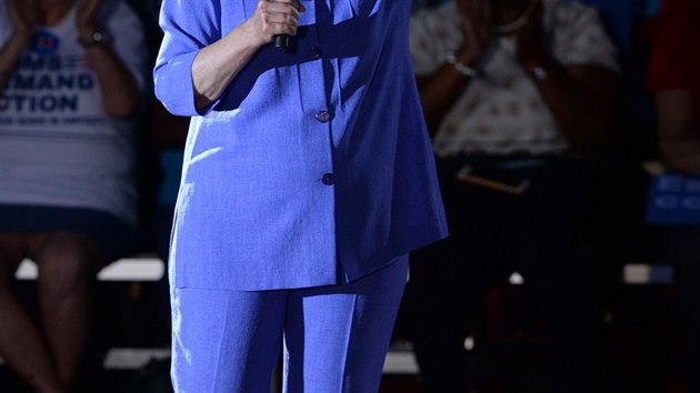 Klasick viz Hillary Clintonov: volnj kostm v ziv barv, lodiky na nzkm podpatku a jeden vrazn perk.
