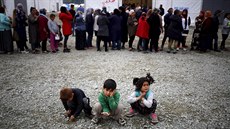 Lidé v uprchlickém táboe Idomeni ekají ve front na jídlo (10. dubna 2016).