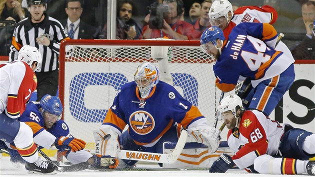 Hokejist Floridy vetn Jaromra Jgra (vpravo dole) se pokouej pekonat obranu New York Islanders, glman Thomas Greiss odolv.