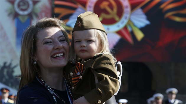 Woman and girl dressed in historical Red Army uniform wait before watching Victory Day parade to mark end of World War Two at Red Square in Moscow