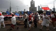 People hold Polish and EU flags as they take part in anti-government...