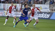 Jihlavský útočník Michael Rabušic (v modrém) se žene za míčem, bedlivě jeho... Jihlavský útočník Michael Rabušic (v modrém) se žene za míčem, bedlivě jeho...