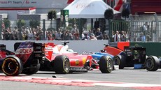 ROZTOENÉ FERRARI. Vz Sebastiana Vettela po kolizi v první zatáce Velké ceny...