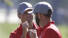 Američtí golfisté Matt Kuchar a Dustin Johnson se radují z birdie. Američtí golfisté Matt Kuchar a Dustin Johnson se radují z birdie.