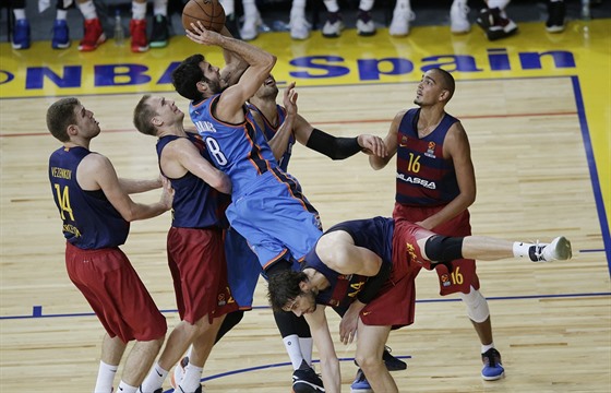 Álex Abrines (v modrém) z Oklahoma City zakonuje na ko svých bývalých...