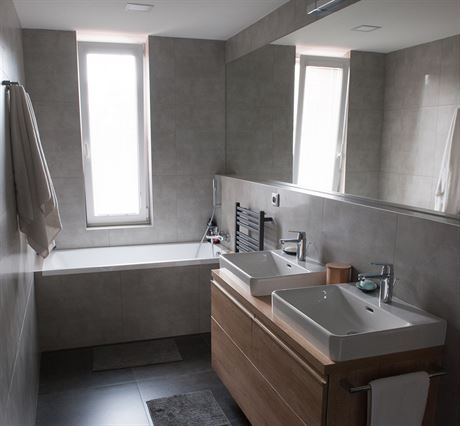 V nov koupeln je sprchov kout, vana, dv umyvadla a tak praka se suikou....