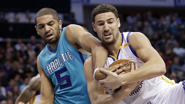 Klay Thompson (vpravo) z Golden State doskoil m, Nicolas Batum z Charlotte mu ho nesebral.