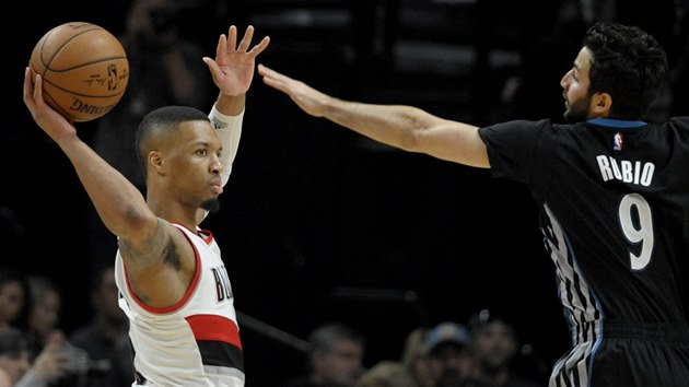 Damian Lillard (vlevo) z Portlandu pihrv kolem Rickyho Rubia z Minnesoty.