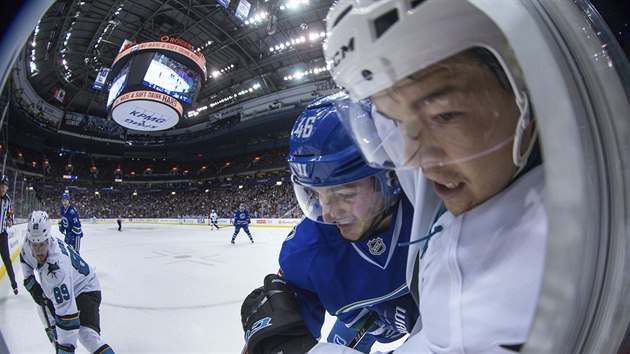 Jayson Megna z Vancouveru (vlevo) a Tom Hertl ze San Jose v souboji.