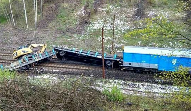 Pohled na nehodu pracovního elezniního vlaku s naloeným bagrem v Havíov....