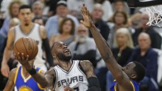 Jonathon Simmons (v bílém) ze San Antonia zakončuje na koš Golden State přes... Jonathon Simmons (v bílém) ze San Antonia zakončuje na koš Golden State přes...