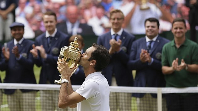 ZASLOUEN SLVA. Osminsobn ampion Wimbledonu Roger Federer lb trofej pro vtze slavnho turnaje.