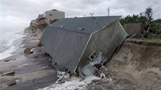 A firefighter views a collapsed coastal house after Hurricane Irma passed the...