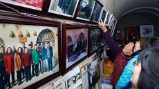 This picture taken on October 22, 2016 shows people looking at photos of... This picture taken on October 22, 2016 shows people looking at photos of...