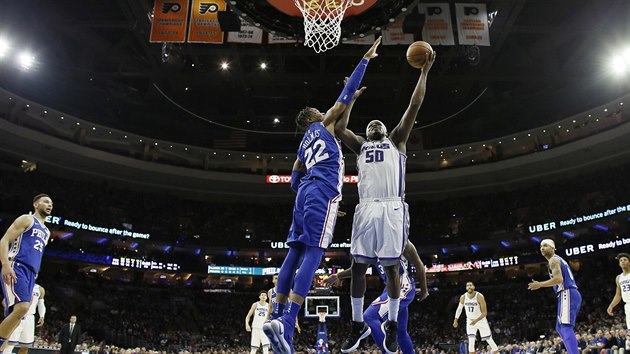 Zach Randolph ze Sacramenta zakončuje na koš přes bránícího Richauna Holmese z Philadelphie.