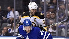 Zdeno Chára (nahoře) z Bostonu brání Dominika Moora z Toronta. Zdeno Chára (nahoře) z Bostonu brání Dominika Moora z Toronta.