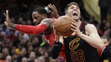 Kyle Korver (v erném) z Clevelandu útoí kolem C. J. Milese z Toronta.