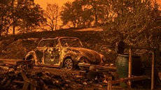 A Volkswagen Beetle scorched by a wildfire called the Carr Fire rests at a... A Volkswagen Beetle scorched by a wildfire called the Carr Fire rests at a...