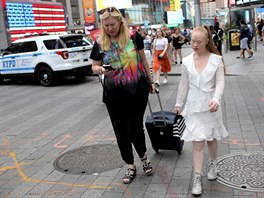 Model Madeline Stuart (R) walks through Times Square with her mother and...