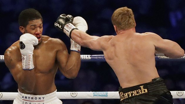 British boxer Anthony Joshua, left, his nose bleeding, fights Russian boxer Alexander Povetkin in their WBA, IBF, WBO and IBO heavyweight titles fight at Wembley Stadium in London, Saturday, Sept. 22, 2018. (AP Photo/Matt Dunham)