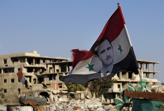 Syrská vlajka s podobiznou prezidenta Baára Asada vlaje ve mst Dúmá. (15....