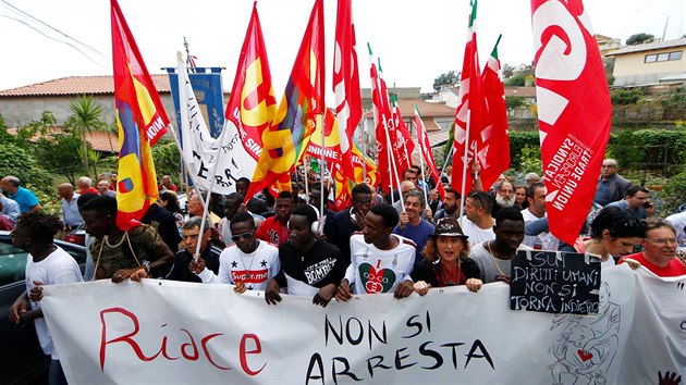 Migrants demonstrate in support of the mayor of the town Domenico Lucano in front of his house in the southern Italian town of Riace, October 6, 2018. The banner reads: "You can't arrest Riace". REUTERS/Yara Nardi