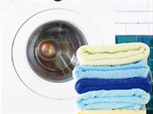 25383482 - pile of colorful  clean towels with washing machine in bathroom