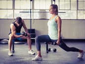 45601746 - serious couple exercising with dumbbells in crossfit gym